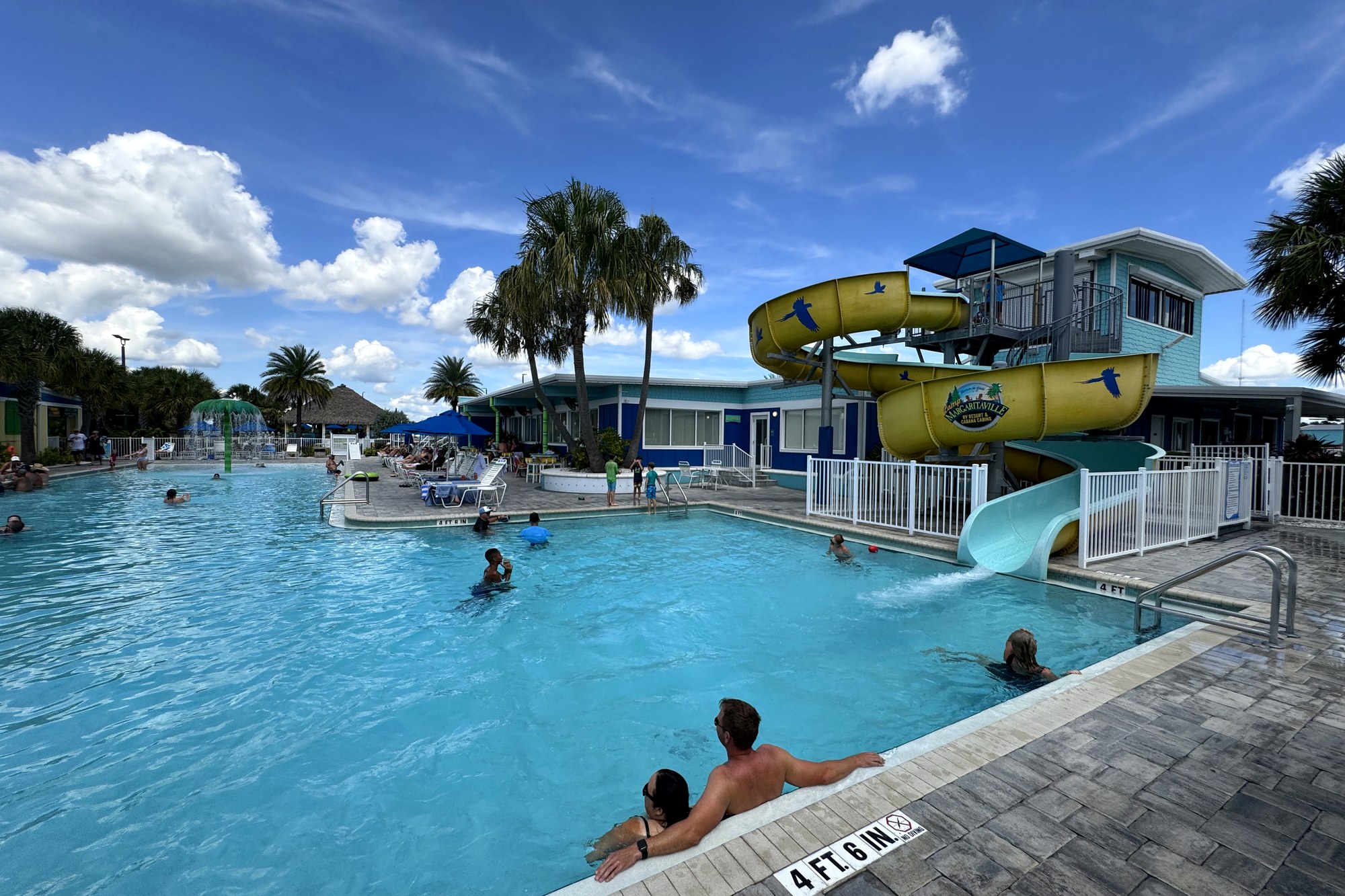 Resort pool with water slides and guests at Camp Margaritaville